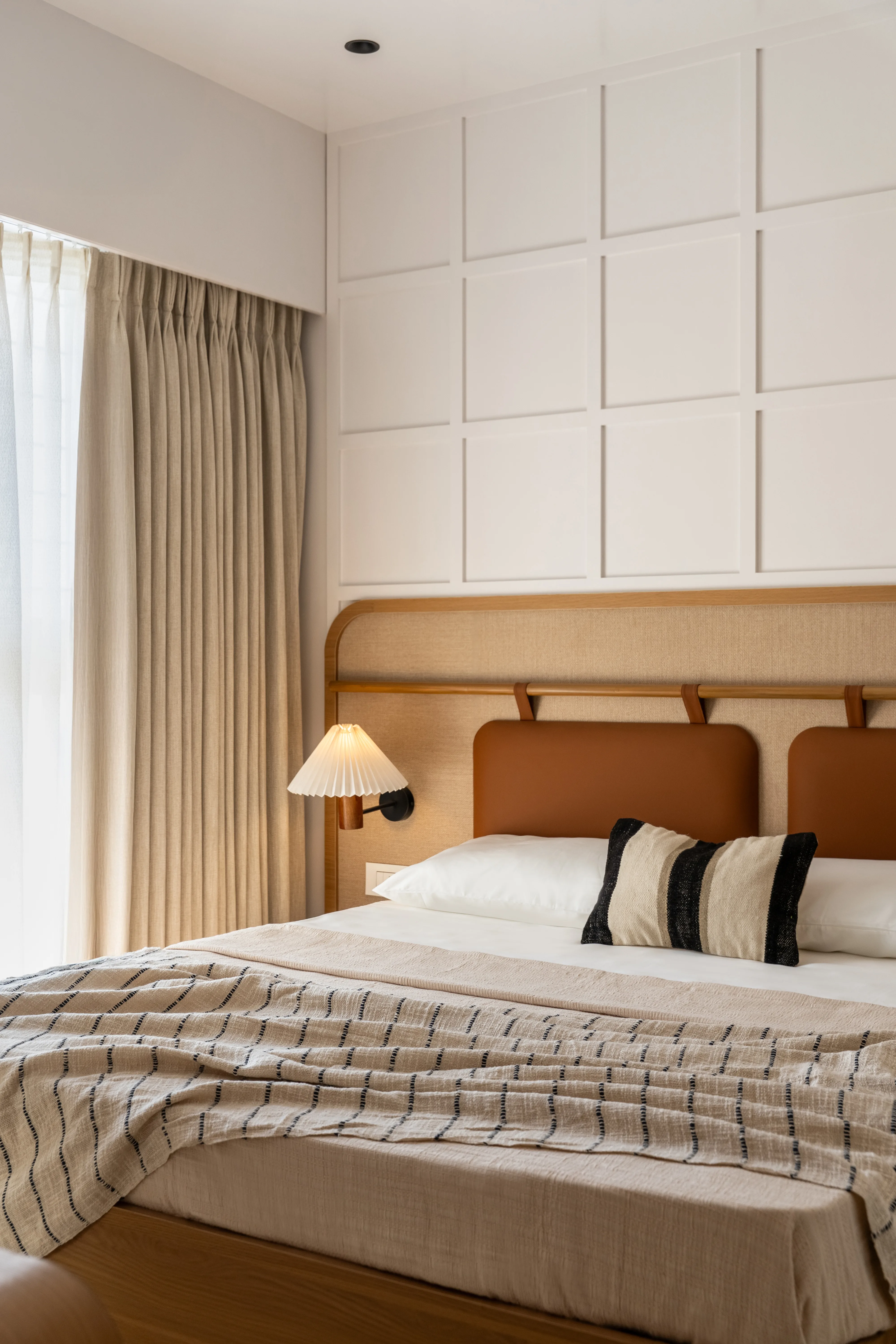 Studio Raama — master bedroom interior with layered textures and warm palette, Pune
